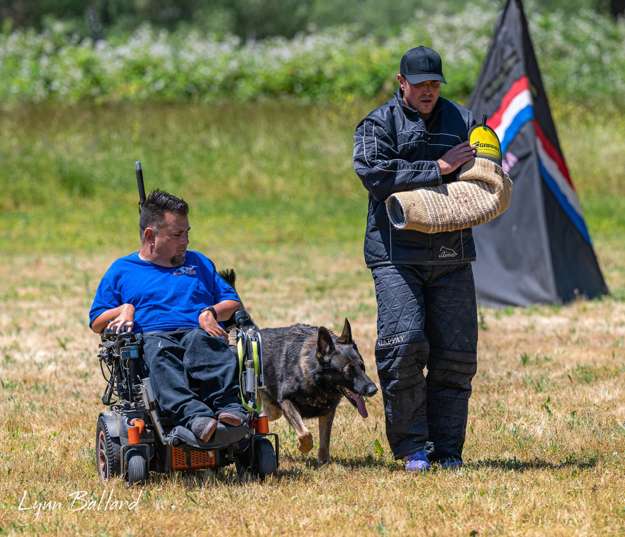Jason Lake coaching a German Shepherd protection exercise with a decoy