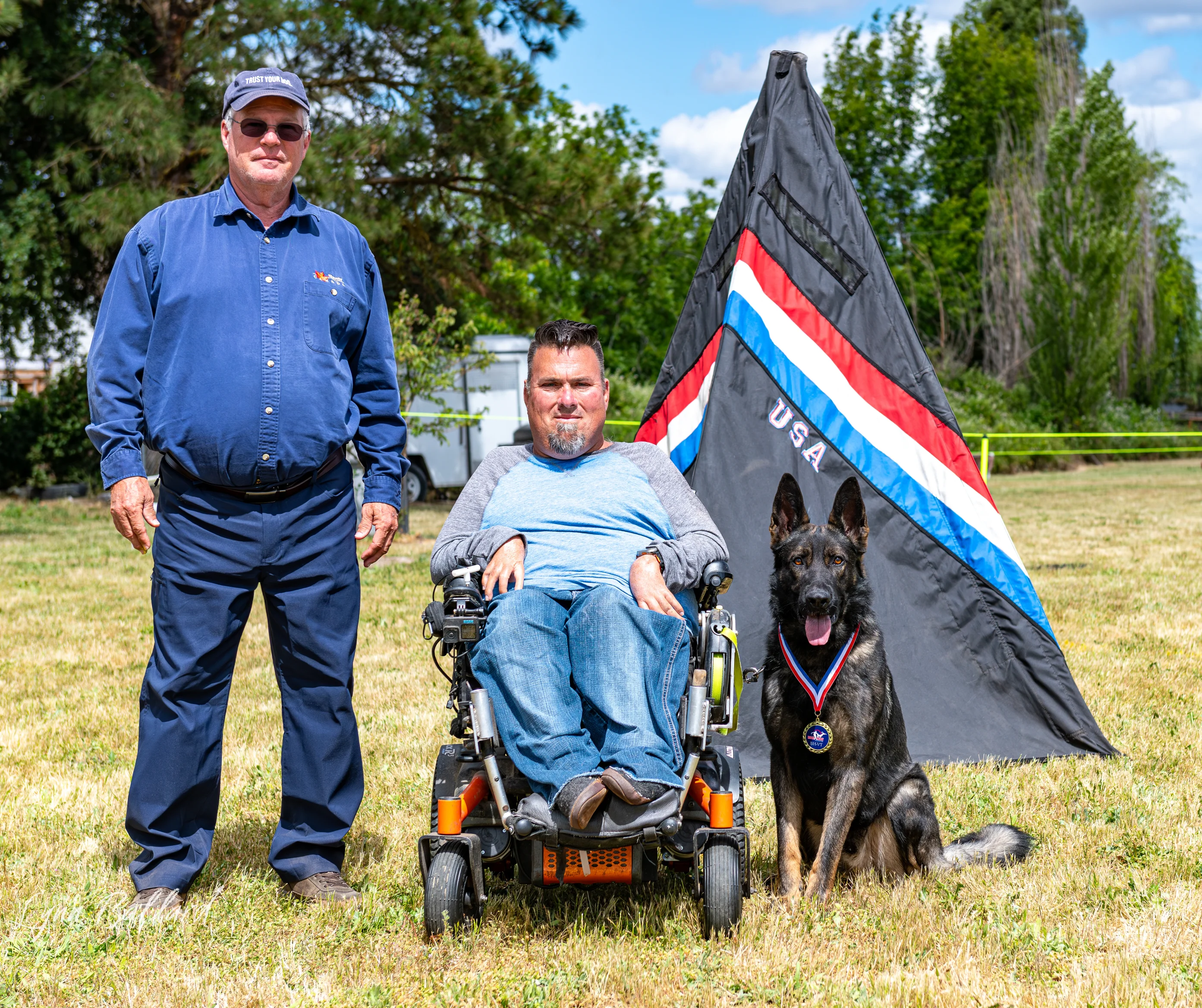 Jason Lake with a Schutzhund club working-dog team and club flag